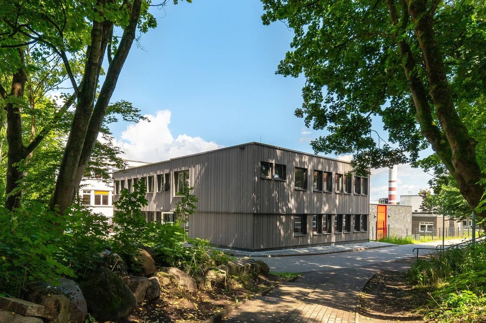 Modular building surrounded by greenery